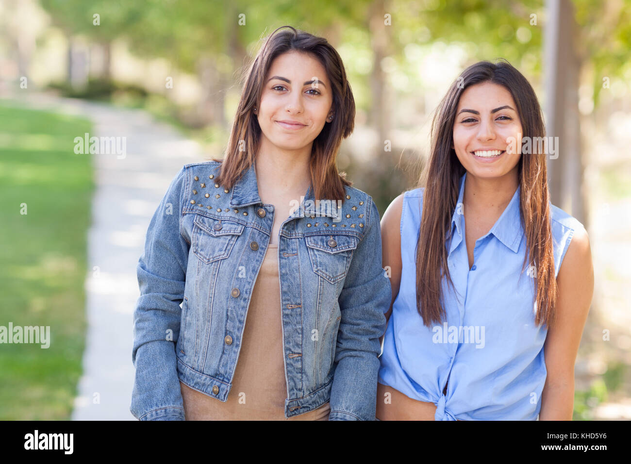 Two Beautiful Ethnic Twin Sisters Portrait Outdoors. Stock Photo