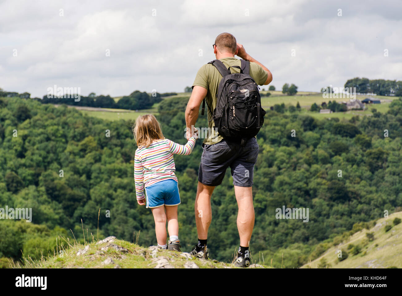 father and daughter looking down from Thorpe cloud, Derbyshire Stock Photo