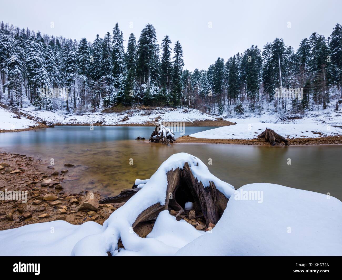 Peaceful lake in early Winter after first snowing Lokvarsko jezero in Croatia near town Lokve Stock Photo