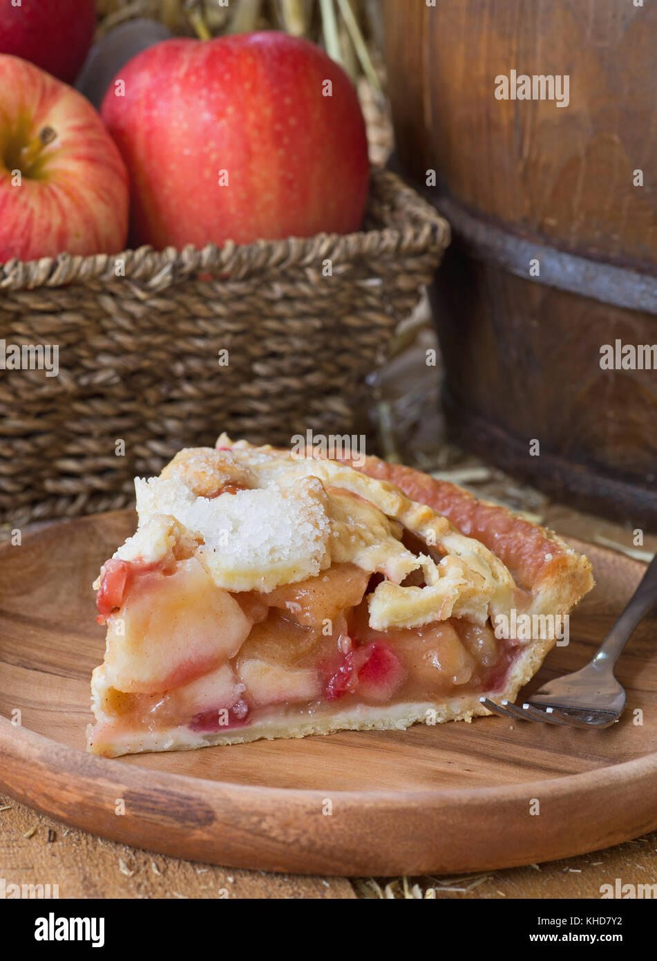 Slice of apple cranberry pie on a wooden plate Stock Photo