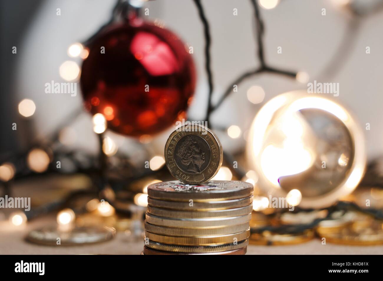 British currency. One pound coin in christmas lights concept Stock