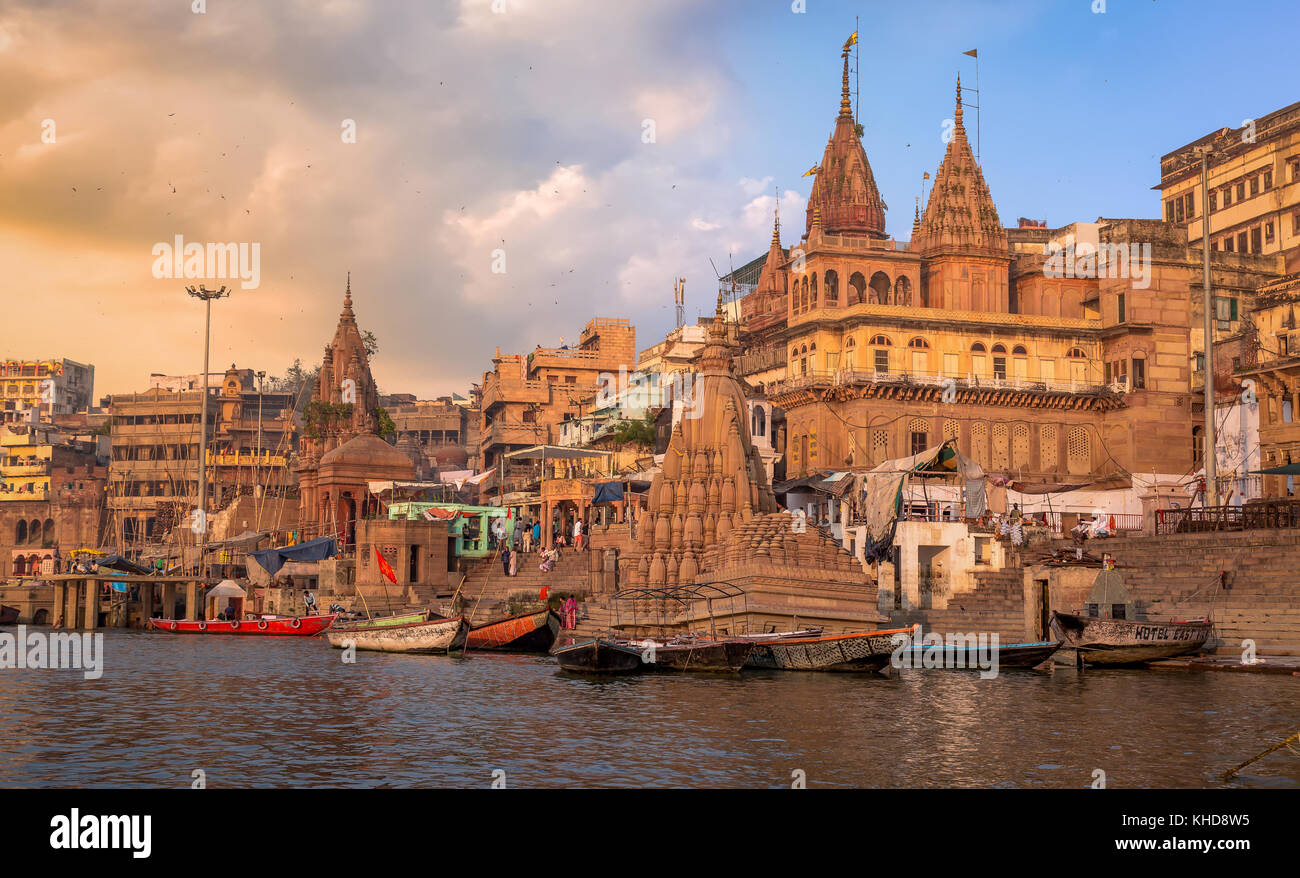 Historic Varanasi city and Ganges river ghat at sunrise with ancient temples and buildings. Stock Photo