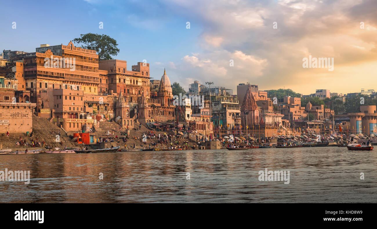 Historic Varanasi city and Ganges river ghat at sunset with ancient temples and buildings. Stock Photo