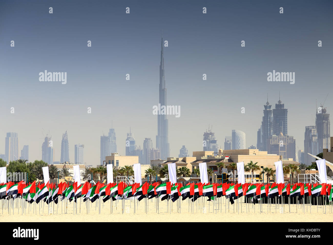 UAE flags on Dubai skyline background. National UAE flag day. Stock Photo