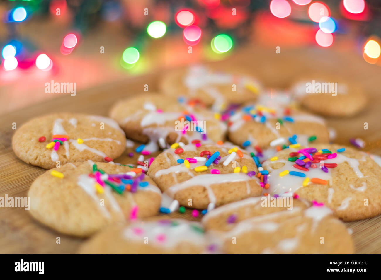 Freshly baked sugar cookies with white icing and rainbow colored