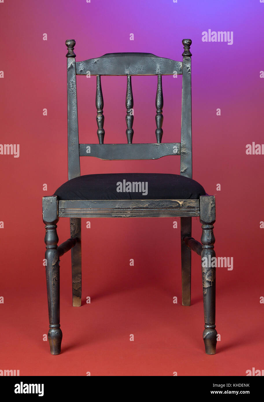 oldfashioned dark wood chair against red wall Stock Photo Alamy