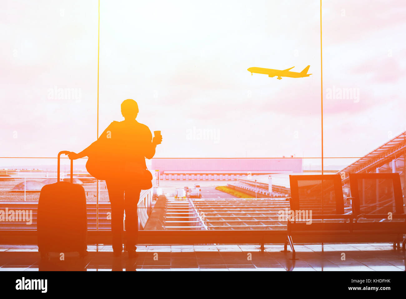people in airport waiting for departure, silhouette of woman passenger traveling with luggage Stock Photo