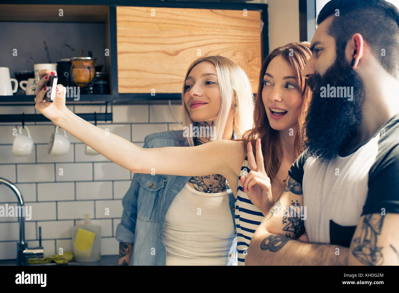 Friends posing together for selfie with smartphone Stock Photo - Alamy
