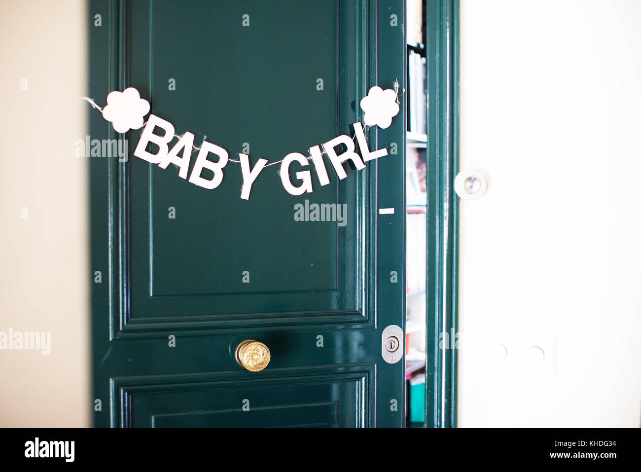 Bunting of baby girl hanging on door Stock Photo