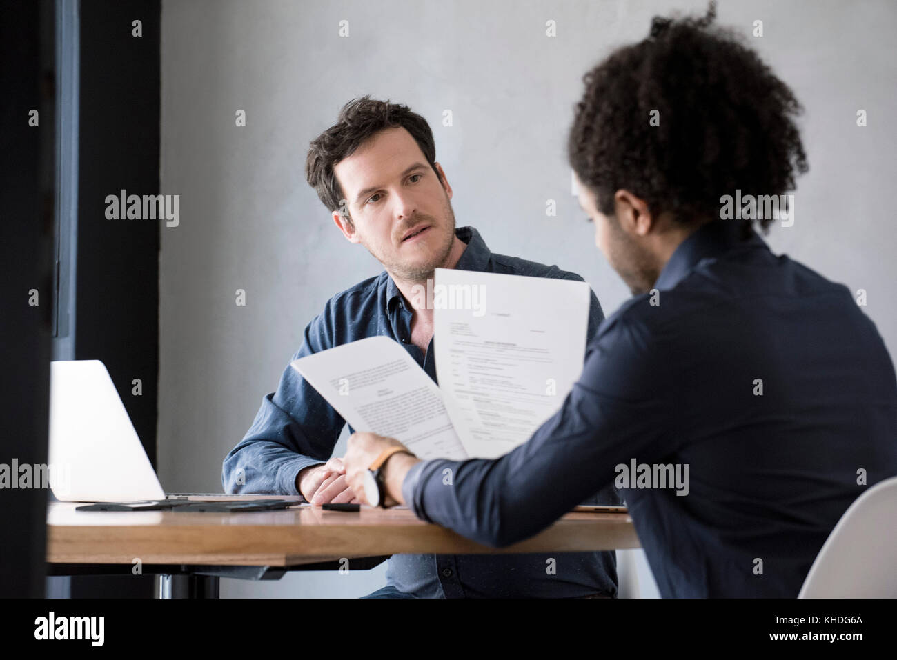 Men reviewing and discussing document Stock Photo