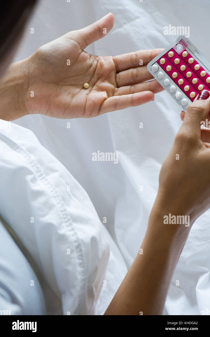 Woman holding birth control pills Stock Photo