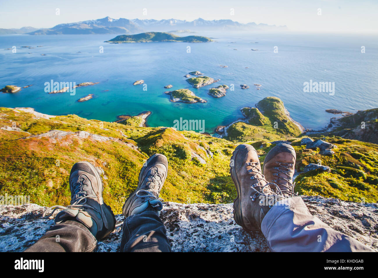 feet of people hikers relaxing on top of the mountain, travel background, hiking shoes Stock Photo