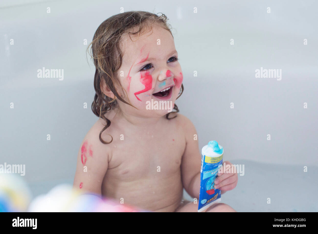 Little girl playing in bathtub Stock Photo