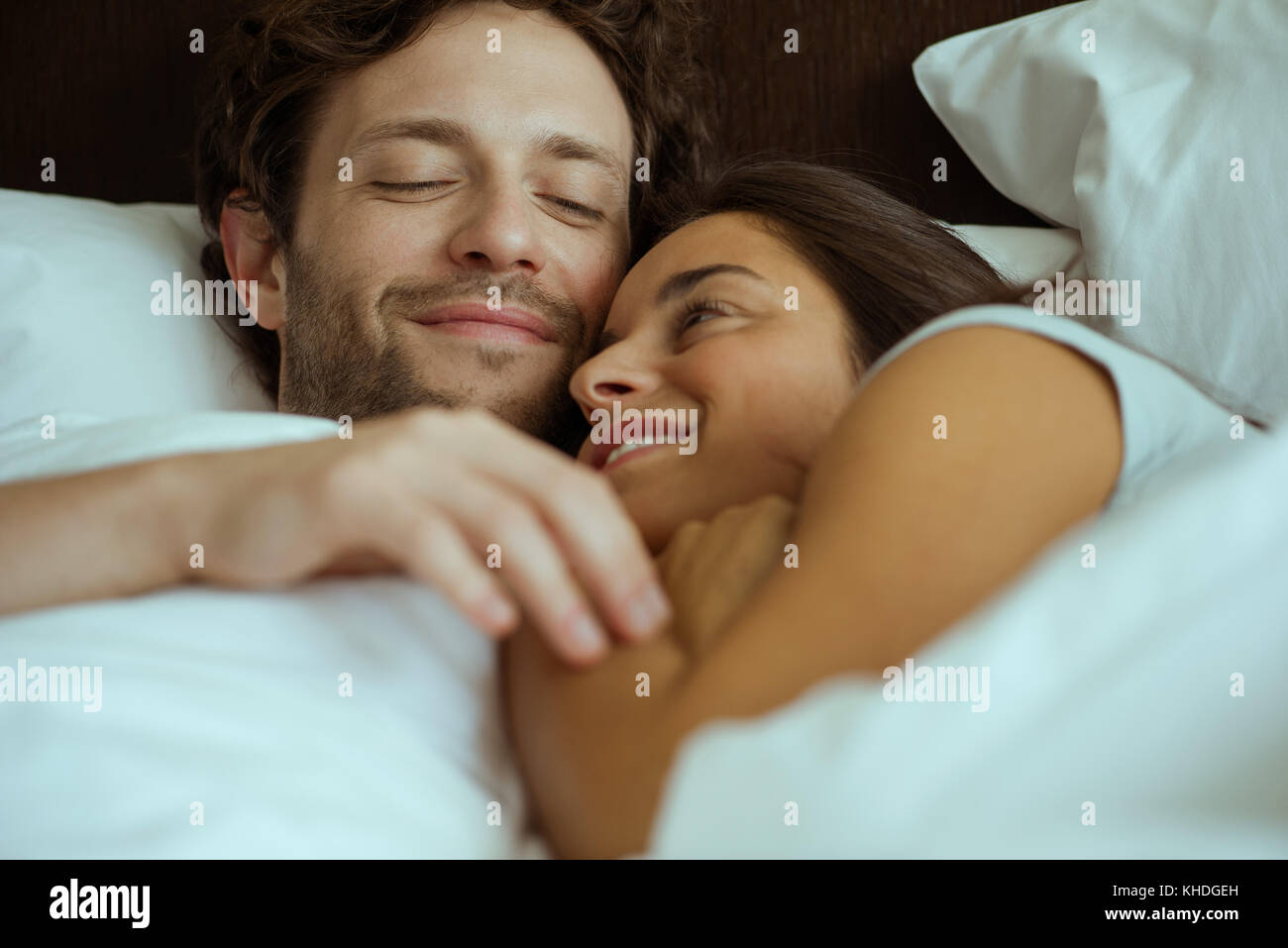 Couple embracing in bed Stock Photo