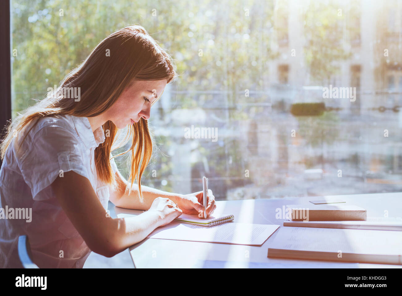 education, student girl in university during exam, young woman studying, people writing test Stock Photo