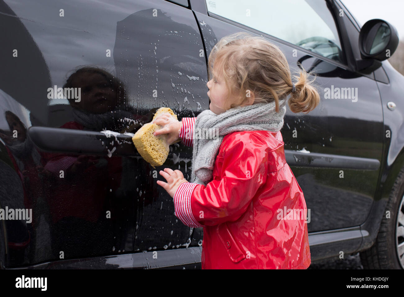Little girl washing car Stock Photo