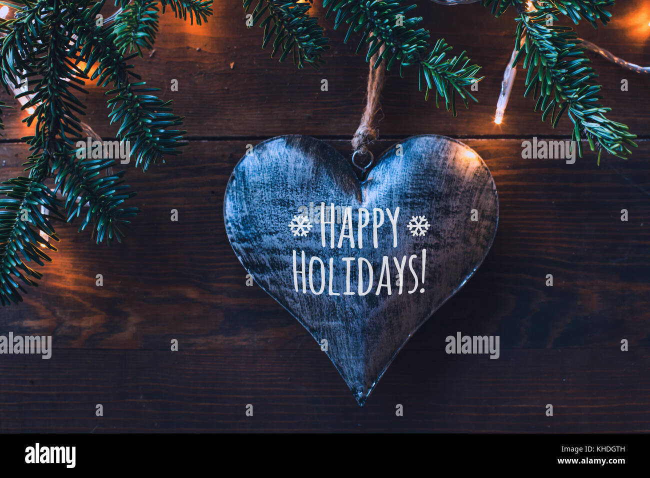 happy holidays greeting card, dark background with heart and love Stock Photo