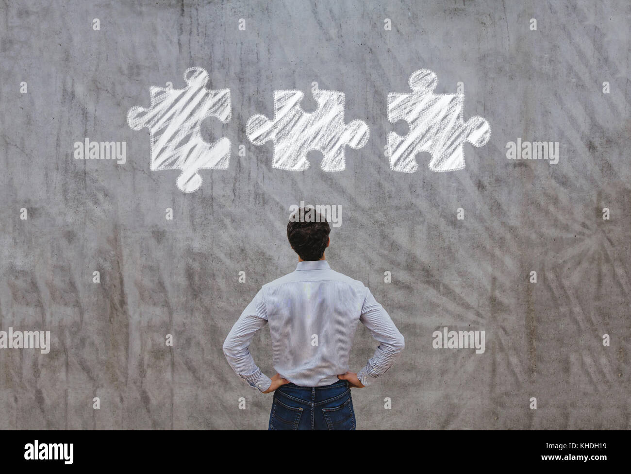 business man looking at the pieces of puzzle, complex solution concept Stock Photo