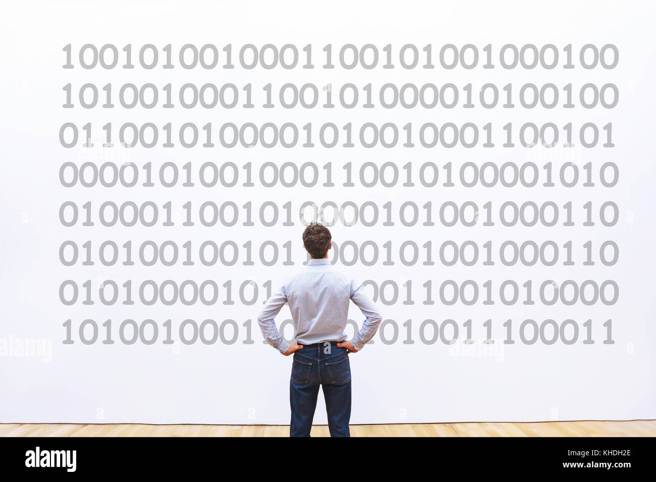 man programmer looking at binary code, coding concept, data encryption Stock Photo