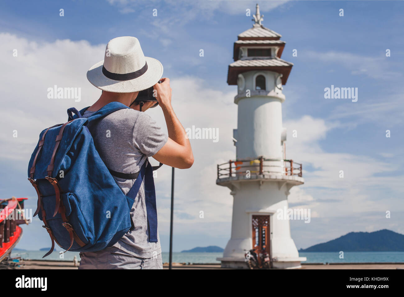 tourist photographer taking photo of lighthouse, travel photography Stock Photo