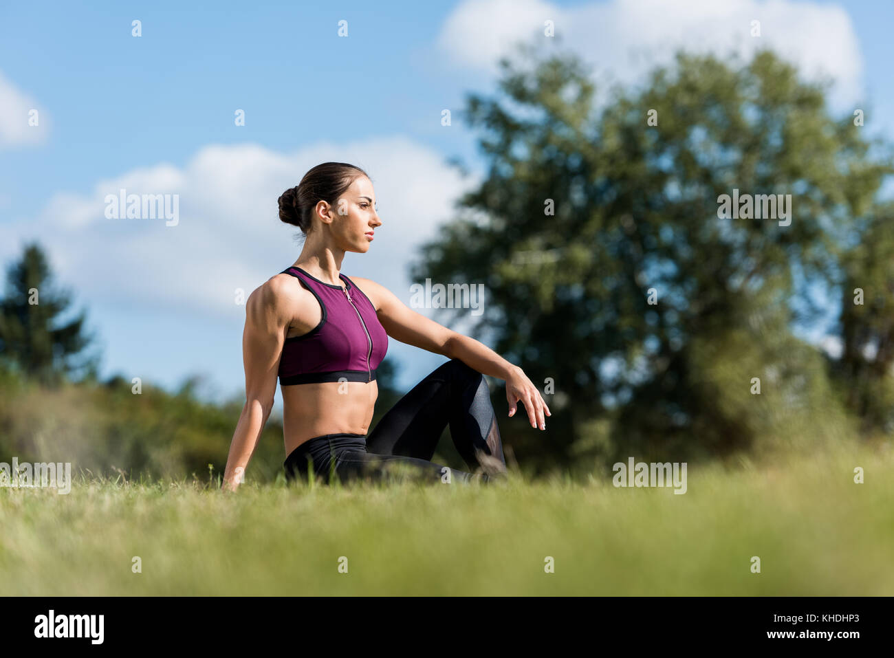 Young girl sitting on grass hi-res stock photography and images - Alamy