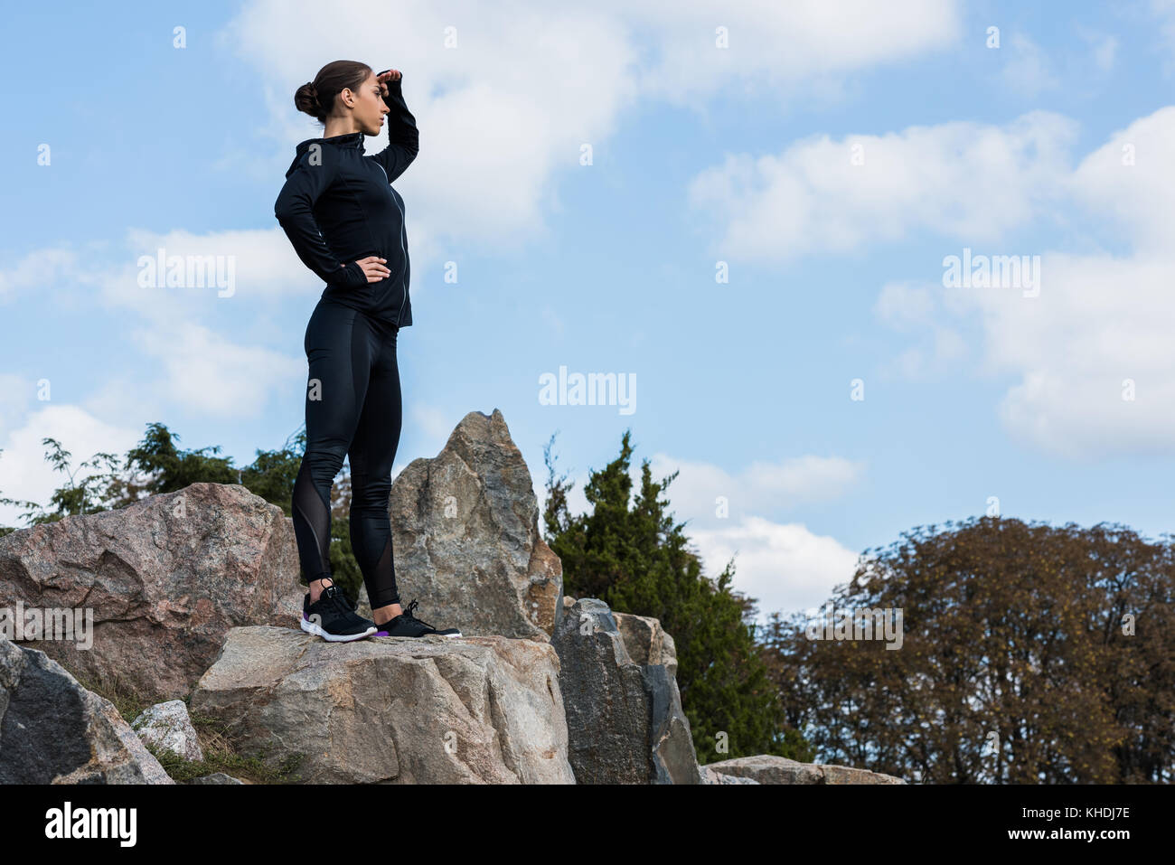 Girl Looking Over Rocks Woman standing on rocks looking hi-res stock photography and images - Alamy