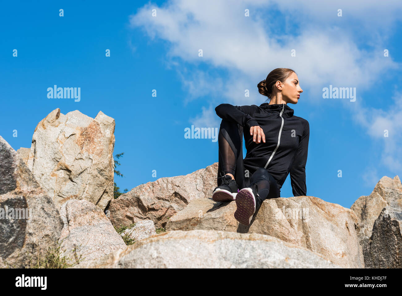 woman sitting on rocks Stock Photo - Alamy