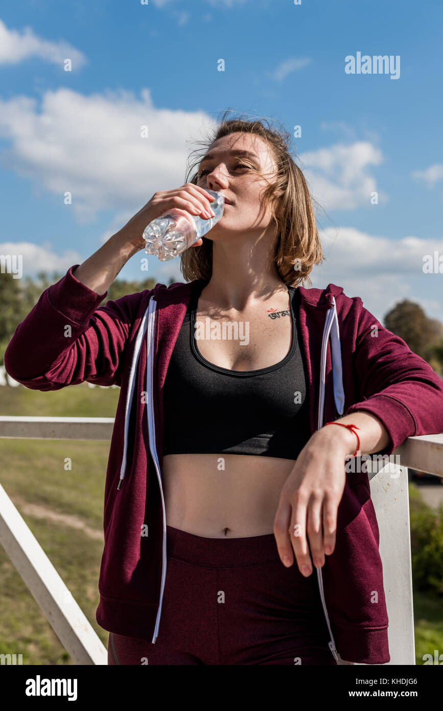 woman drinking water after workout Stock Photo Alamy