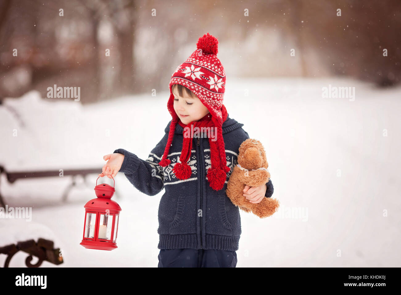 Cute little caucasian boy with teddy bear and red lantern, playing in ...