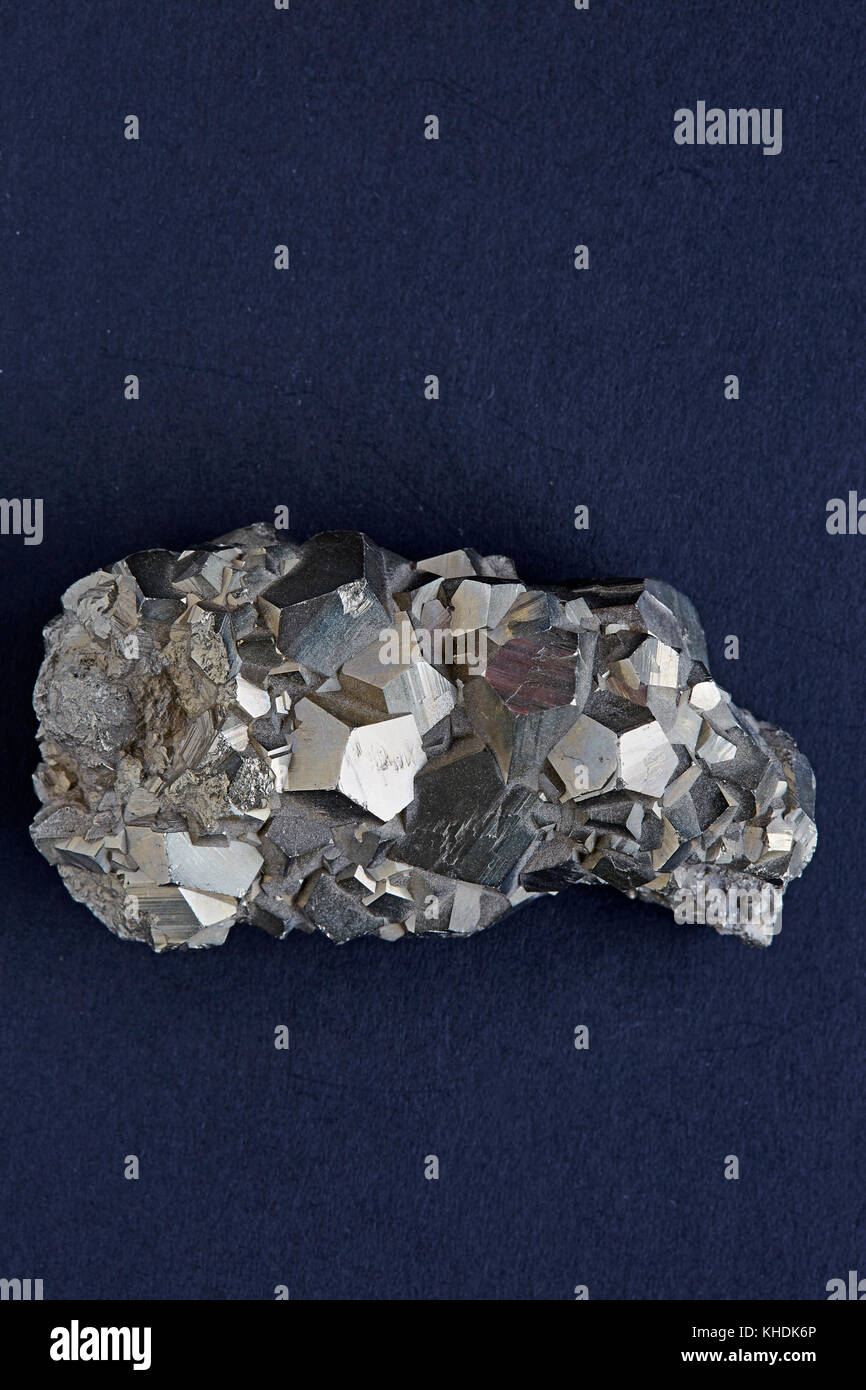 A specimen of a rough pyrites rock with a dark background Stock Photo ...