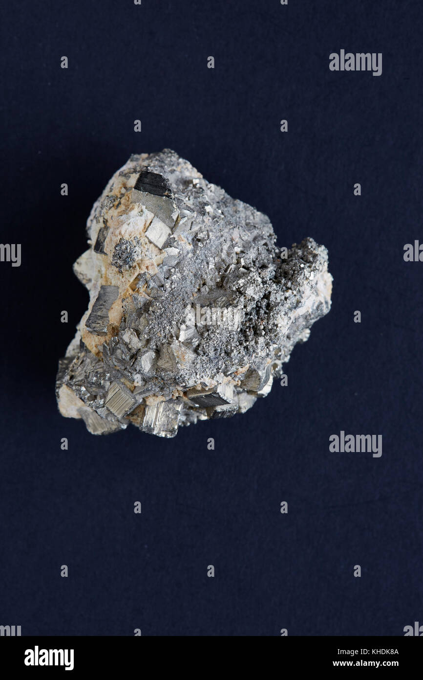 A specimen of a rough pyrites rock with a dark background Stock Photo ...
