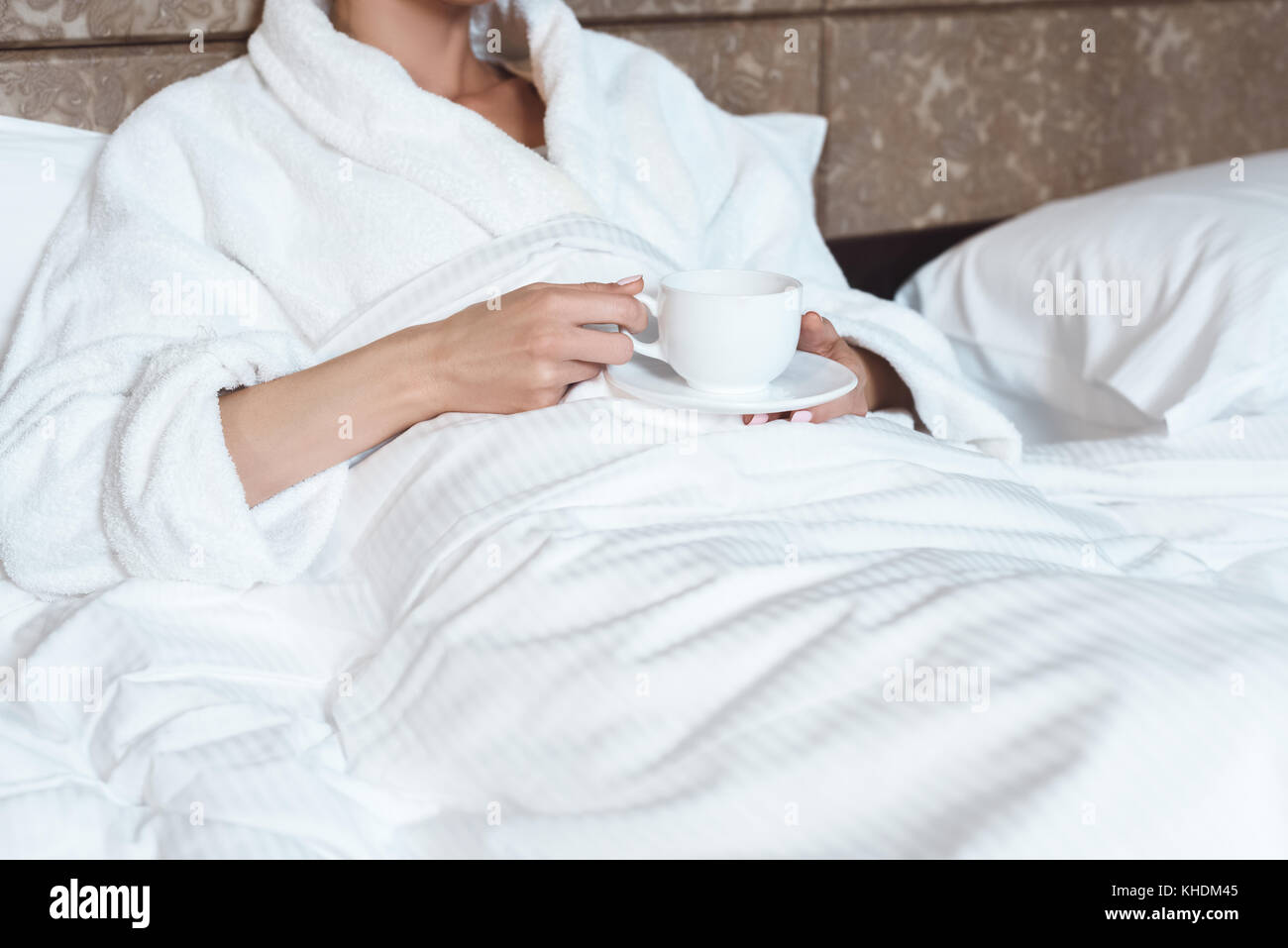 woman in bathrobe drinking coffee Stock Photo Alamy