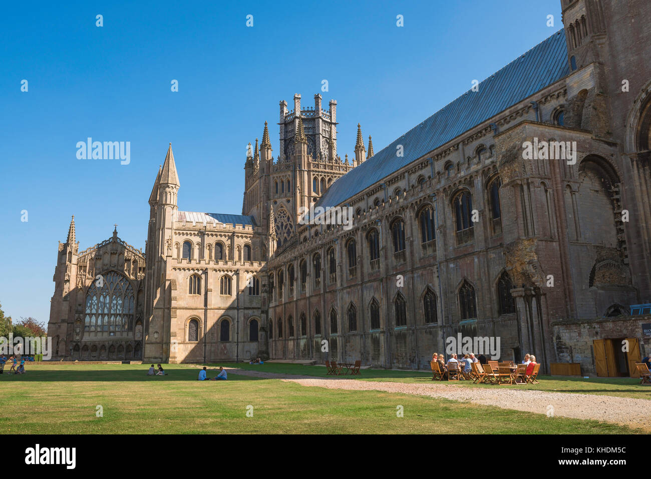 Ely Cathedral, view in summer of a group of visitors to Ely Cathedral enjoying afternoon tea on the cathedral green, Cambridgeshire, England, UK Stock Photo