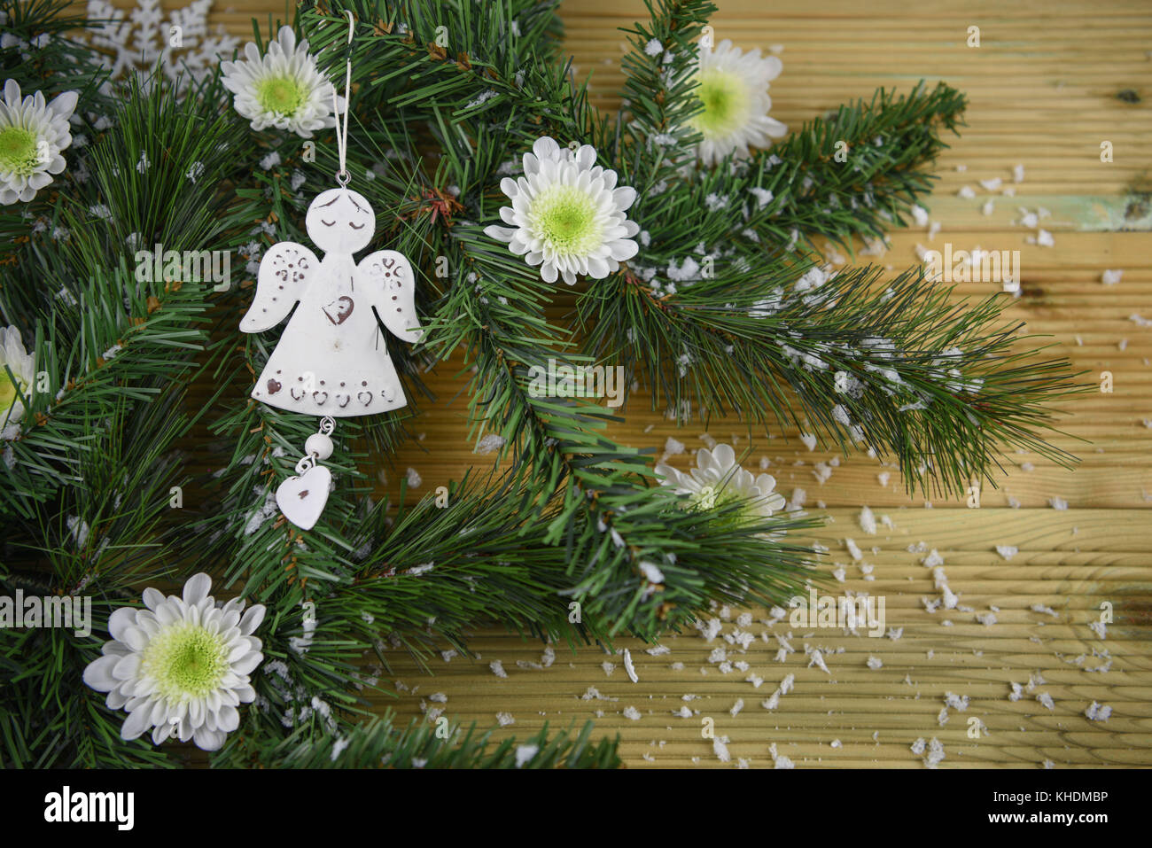 Festive winter tree decorations with large silky poinsettia flowers,  glitter tree balls and golden mesh ribbons, seasonal Christmas ornamentas  Stock Photo - Alamy