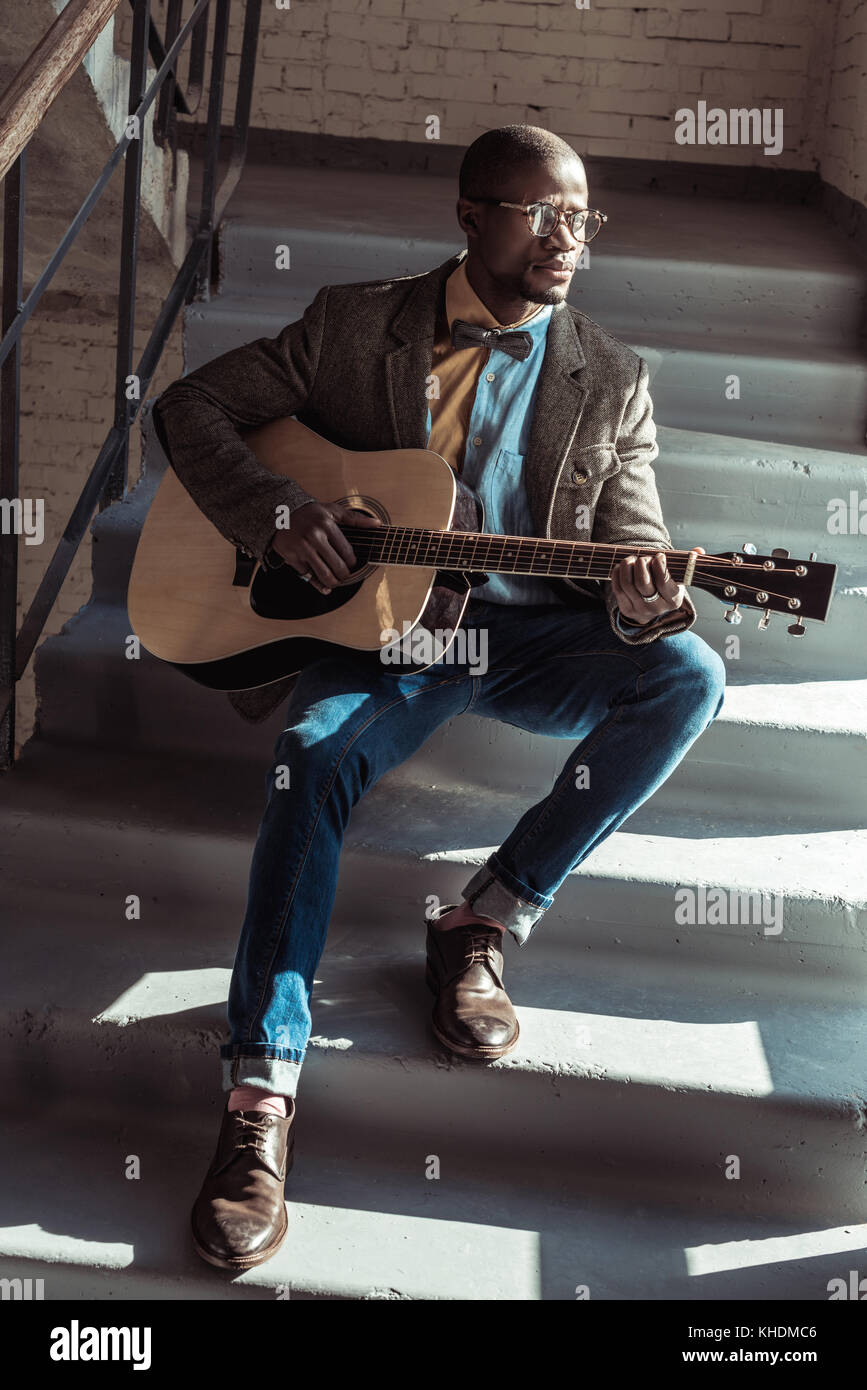 Man playing guitar on stairs hi-res stock photography and images - Alamy