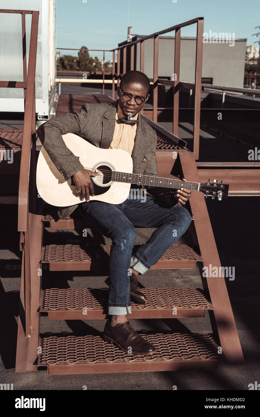 african american man on stairs playing guitar Stock Photo - Alamy