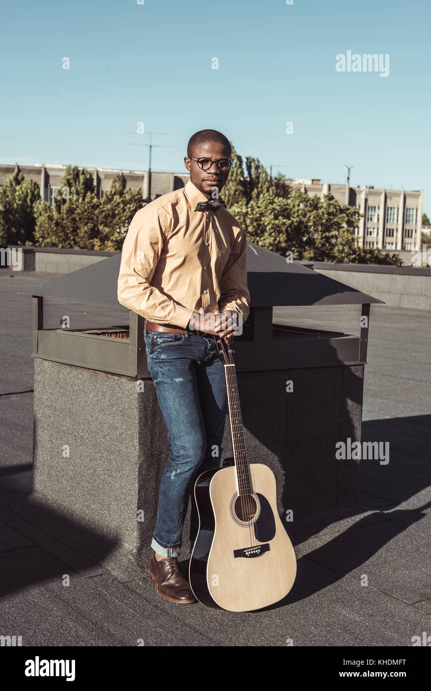 Young african american man holding guitar Stock Photo - Alamy