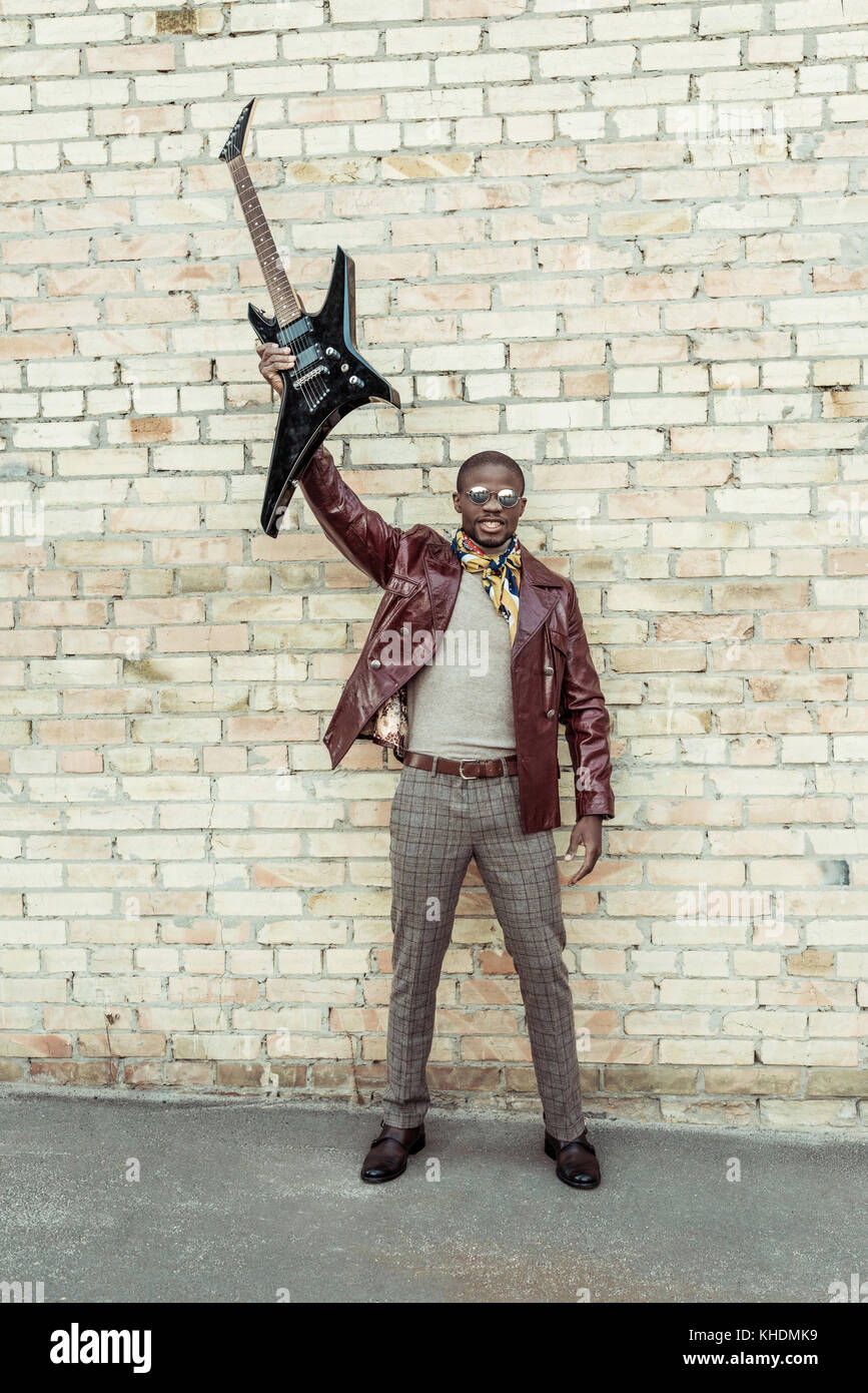 Young african american man holding guitar Stock Photo - Alamy