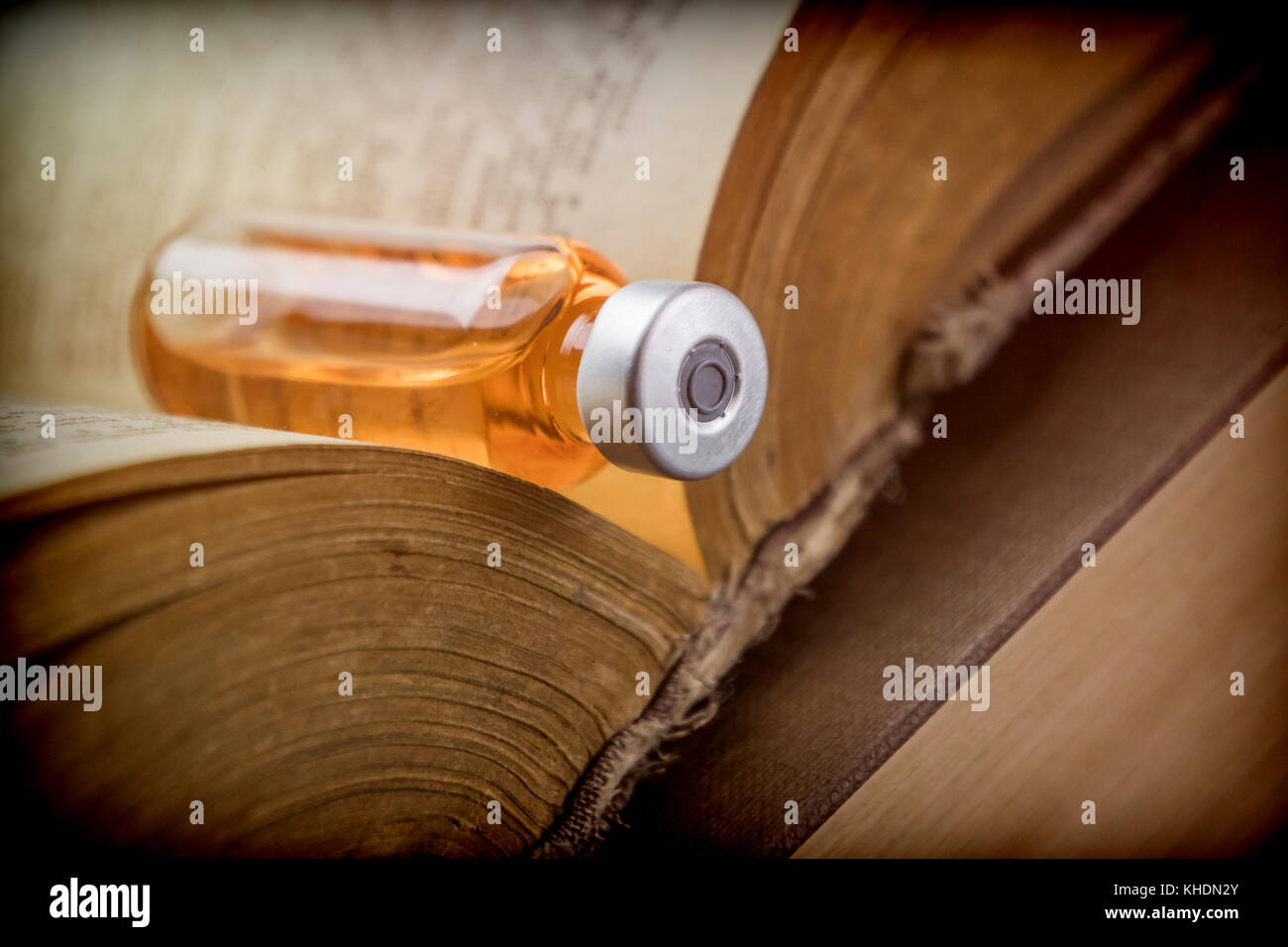 Vial On An Old Book Of Medicine, Conceptual Image Stock Photo