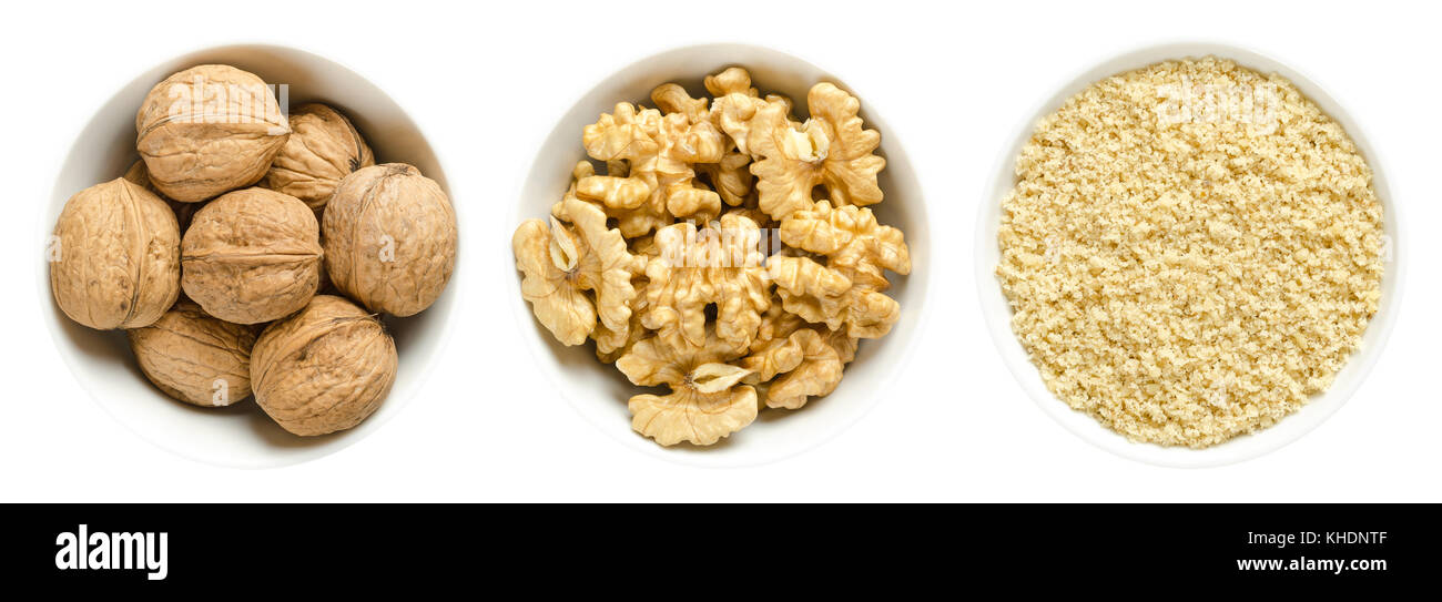 Whole walnuts, kernel halves and ground walnuts in white bowls on white background. Seeds of the common walnut tree Juglans regia. Photo. Stock Photo