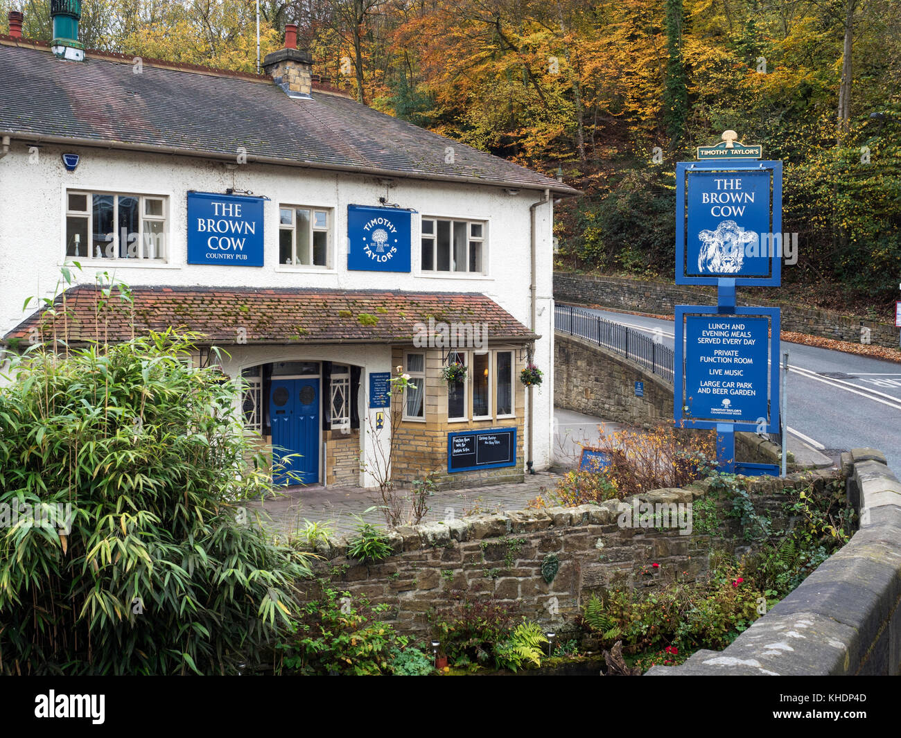 The Brown Cow Pub in Autumn from Ireland Bridge on Harden Road Bingley West Yorkshire England Stock Photo