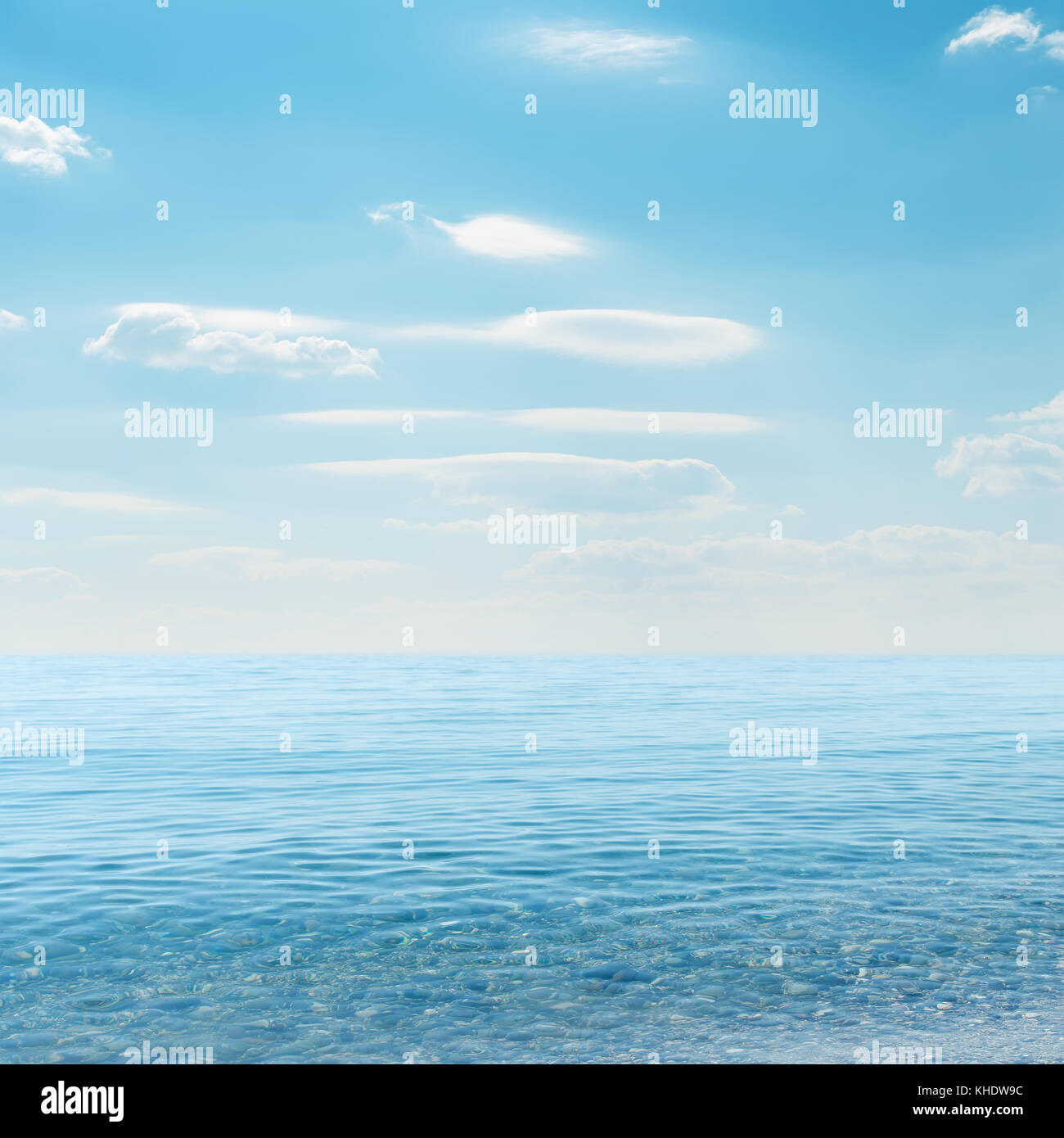 light clouds on sky over blue sea Stock Photo - Alamy