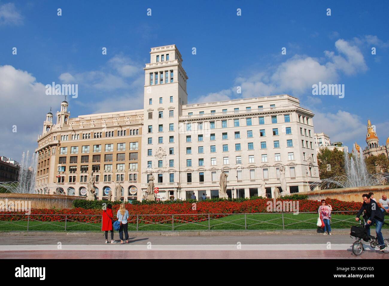 People walk in the Placa de Catalunya in Barcelona, Spain on November 1, 2017. The flagship store of clothing brand Desigual is in the background. Stock Photo