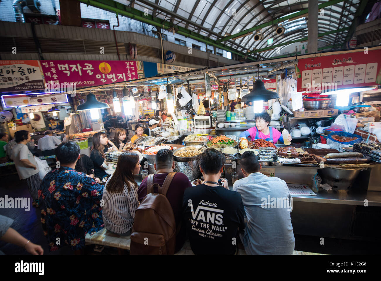 Koreans sitting and eating at a street food vendor in Kwangjang Food Market, Seoul 2017. Stock Photo