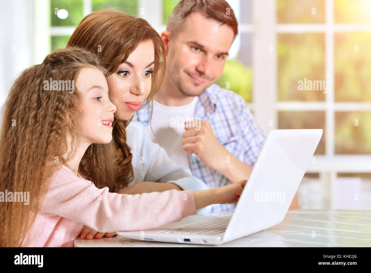 Happy family with laptop Stock Photo - Alamy