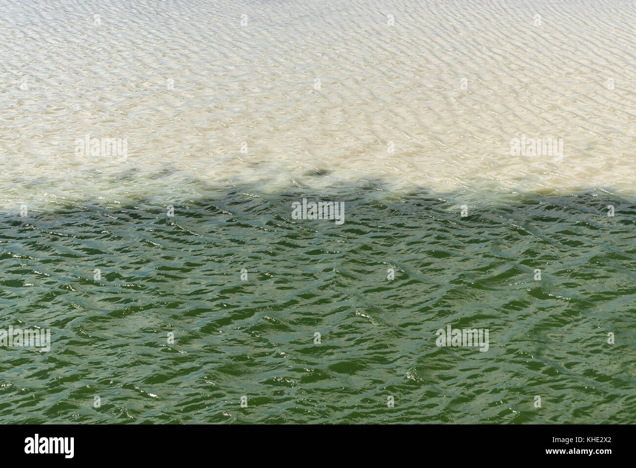 Beautiful abstract decorative background with white and turquoise water at the merger of two rivers Stock Photo