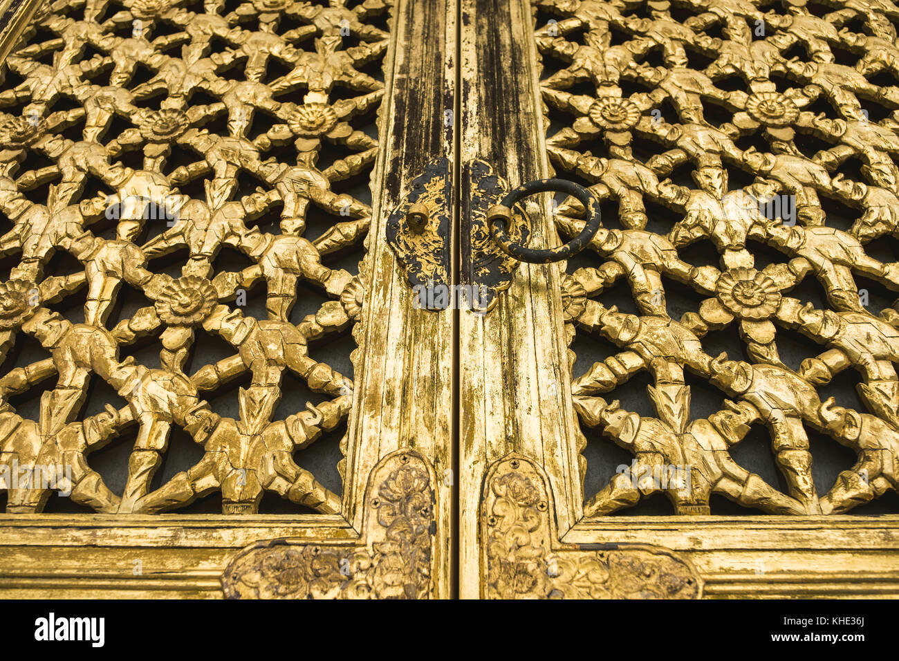 The worn out door to a temple in korea painted in gold paint. Stock Photo