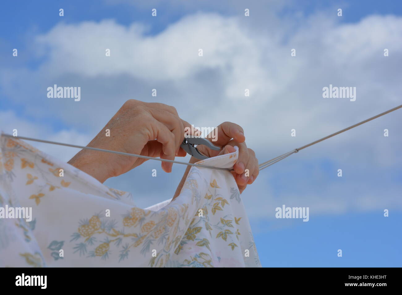 Laundry day. Hanging out the washing on a clothes line outdoors. Stock Photo