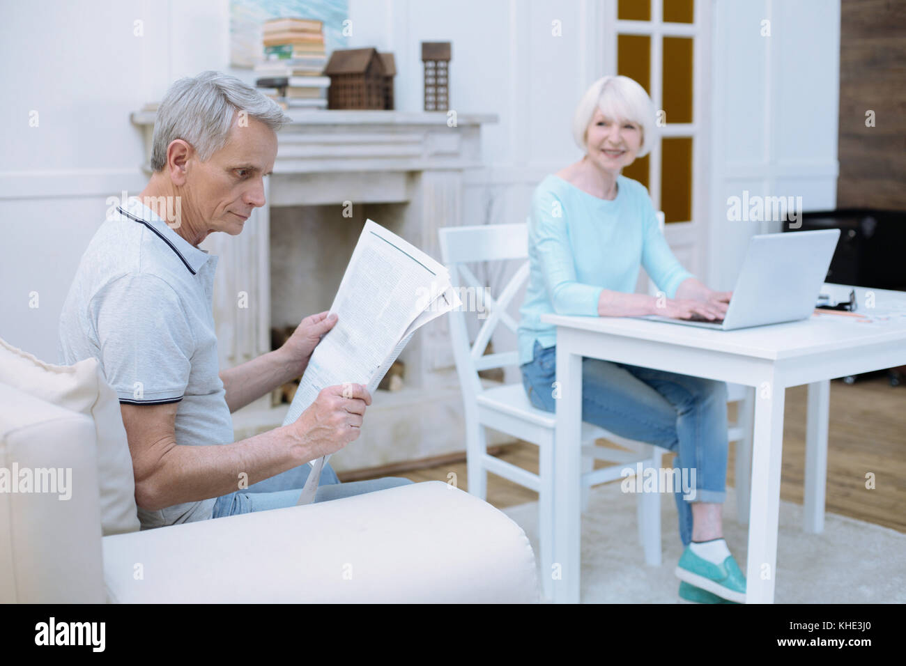 Concentrated old man reading a wonderful newspaper Stock Photo