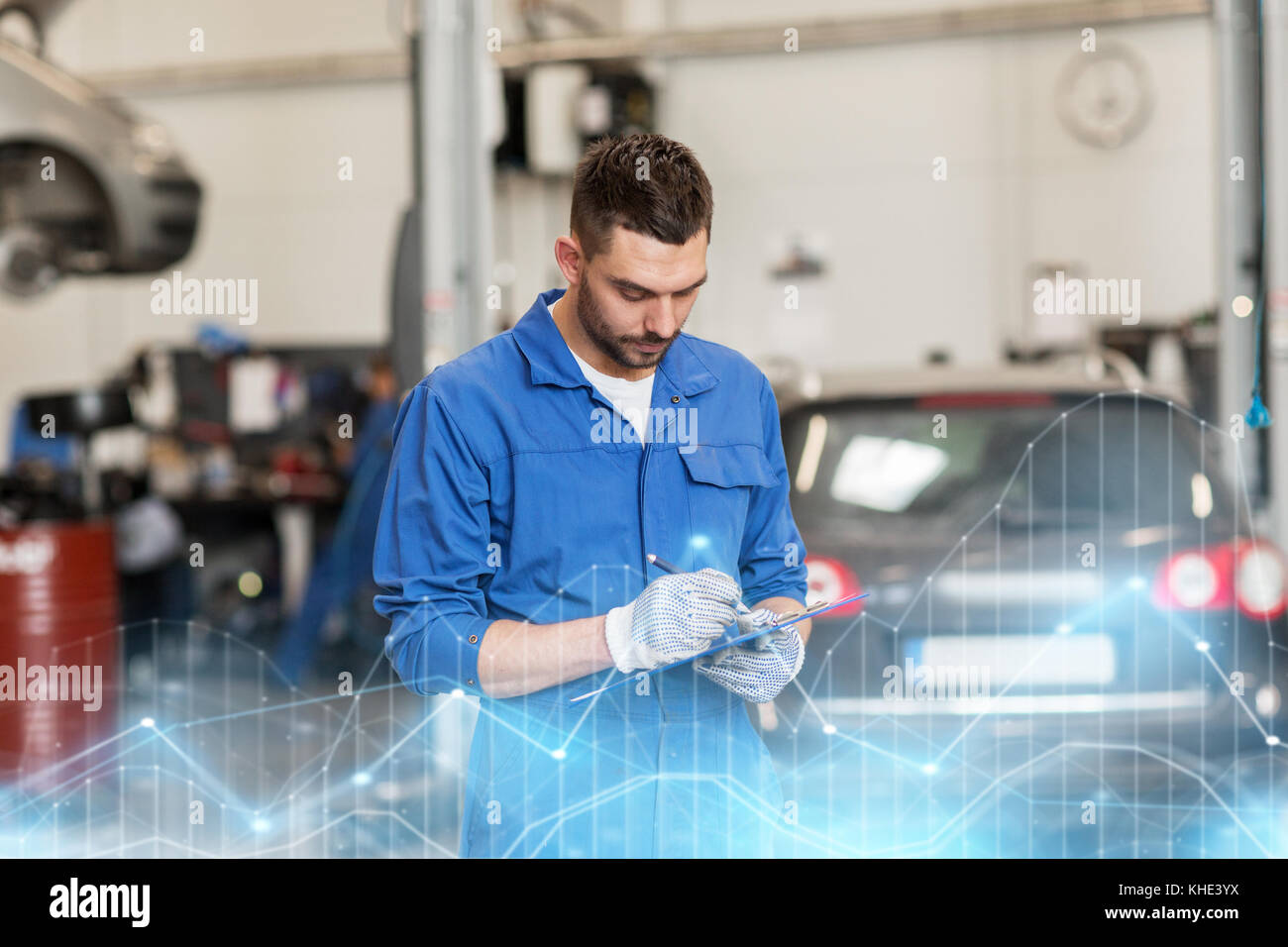 auto mechanic man with clipboard at car workshop Stock Photo
